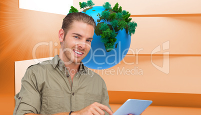 Composite image of happy man using tablet pc