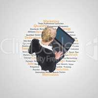 Composite image of businesswoman using laptop