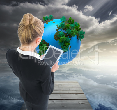 Composite image of businesswoman holding new tablet