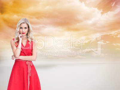 Composite image of thoughtful blonde wearing red dress