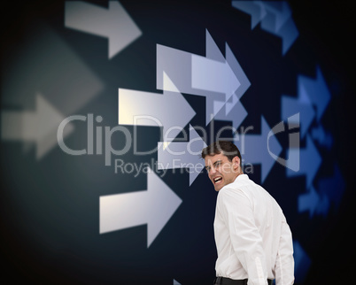 Composite image of rear view of young businessman wearing handcu