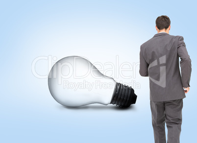 Composite image of young businessman walking away from camera