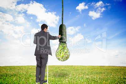 Composite image of businessman standing on ladder