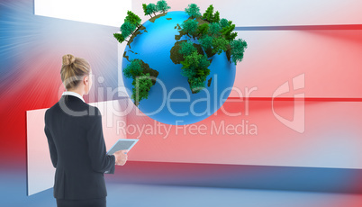 Composite image of businesswoman holding new tablet