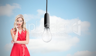 Composite image of thoughtful blonde wearing red dress