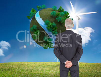 Composite image of rear view of serious businessman posing