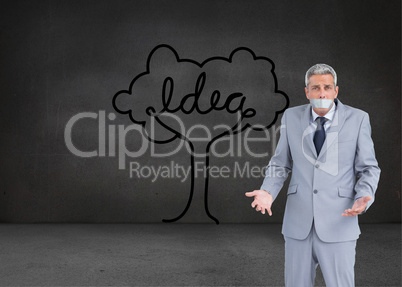 Composite image of businessman gagged with adhesive tape on mout