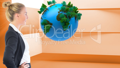 Composite image of businesswoman standing with hands on hips