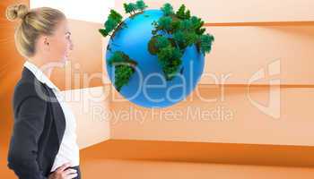 Composite image of businesswoman standing with hands on hips