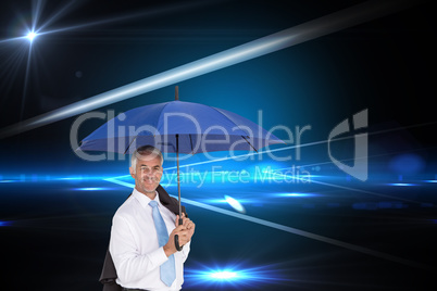 Composite image of businessman holding umbrella smiling at camer