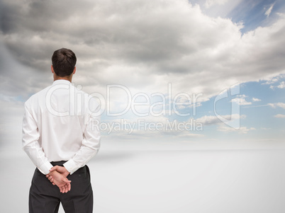 Composite image of businessman turning his back to camera