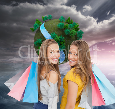 Composite image of two young women with shopping bags