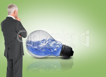 Composite image of thoughtful businessman standing back to camer