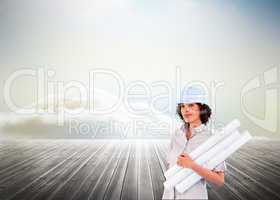 Composite image of confident woman holding construction plans