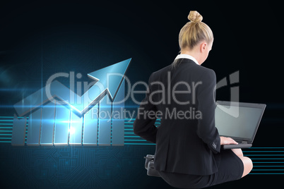 Composite image of businesswoman using laptop