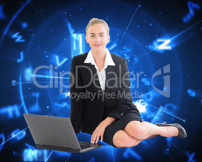 Composite image of businesswoman using laptop