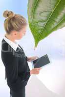 Composite image of businesswoman holding tablet