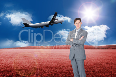 Composite image of assertive businessman standing