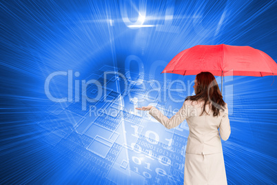 Composite image of businesswoman holding umbrella