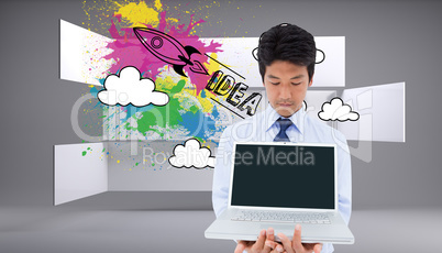 Composite image of businessman showing a laptop