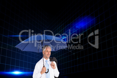 Composite image of happy businessman holding umbrella