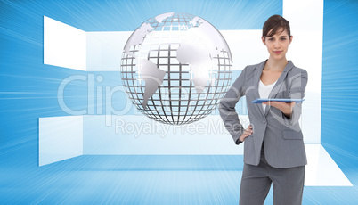 Composite image of attractive businesswoman holding tablet pc