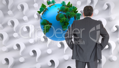 Composite image of businessman standing back to the camera with