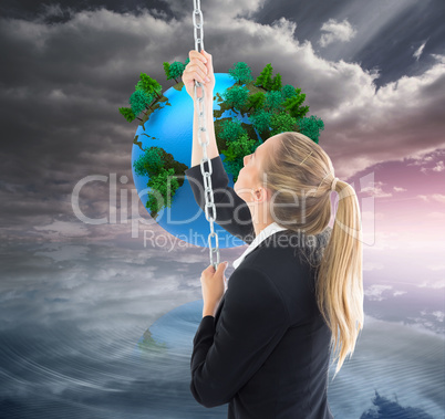 Composite image of businesswoman pulling a chain