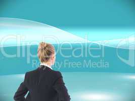 Composite image of businesswoman standing with hands on hips