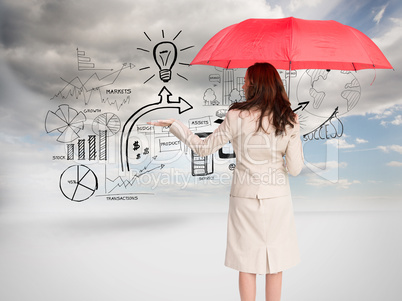 Composite image of businesswoman holding umbrella