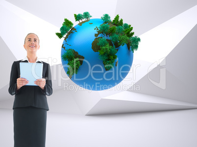 Composite image of businesswoman holding new tablet