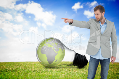 Composite image of trendy model pointing to something