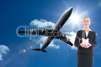 Composite image of businesswoman holding pink piggy bank