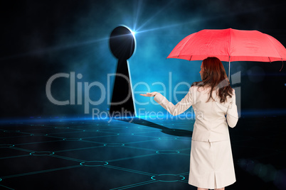 Composite image of businesswoman holding umbrella