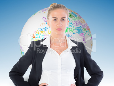 Composite image of businesswoman standing with hands on hips