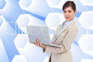 Composite image of confident young businesswoman with laptop