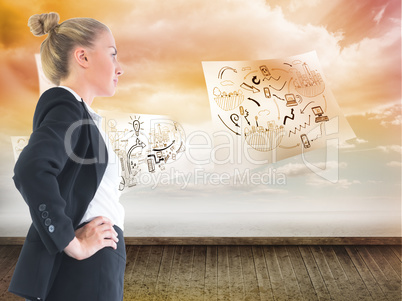 Composite image of businesswoman standing with hands on hips