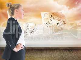 Composite image of businesswoman standing with hands on hips