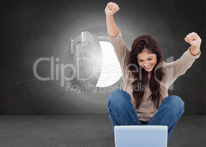 Composite image of brunette cheering while using laptop