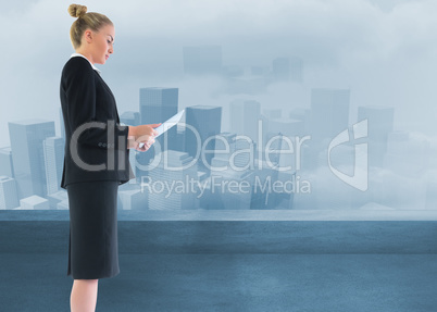 Composite image of businesswoman holding new tablet