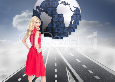 Composite image of smiling blonde standing hands on hips