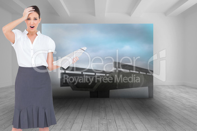 Composite image of shocked classy businesswoman holding newspape