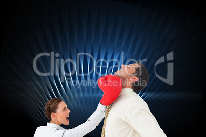Composite image of businesswoman hitting a businessman with boxi