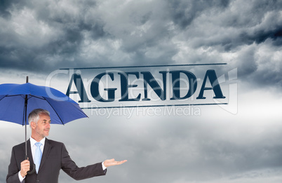 Composite image of happy businessman holding umbrella