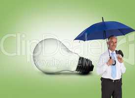 Composite image of happy businessman holding umbrella