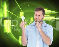 Composite image of sceptical model holding a bulb