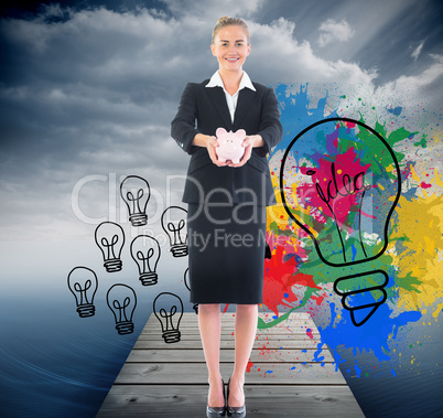 Composite image of happy businesswoman holding a piggy bank