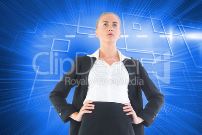 Composite image of businesswoman standing with hands on hips