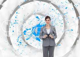 Composite image of young businesswoman with binoculars