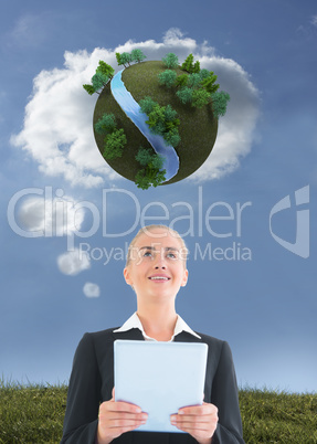 Composite image of businesswoman holding tablet